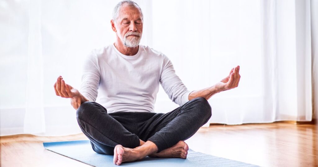 person meditating in bedroom
